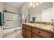 This bathroom features a granite countertop, wood cabinets and a glass enclosed shower at 1450 Shady Meadow Ln, Deland, FL 32724