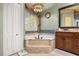 Luxurious bathroom with a soaking tub, a decorative window, and a granite vanity at 1450 Shady Meadow Ln, Deland, FL 32724