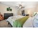 Well-lit bedroom with a ceiling fan, carpet flooring, a television and decor at 1450 Shady Meadow Ln, Deland, FL 32724