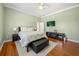 Comfortable bedroom features soft natural light, hardwood floors, and neutral color palette at 1450 Shady Meadow Ln, Deland, FL 32724
