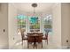 Cozy breakfast nook with a chandelier and views of the pool through large windows at 1450 Shady Meadow Ln, Deland, FL 32724