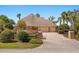 Exterior of home with a three-car garage, lush landscaping, and a brick-paved driveway at 1450 Shady Meadow Ln, Deland, FL 32724
