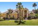 Stunning two-story home featuring mature landscaping, a manicured lawn, and classic architectural details at 1450 Shady Meadow Ln, Deland, FL 32724