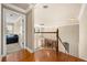 Upper hallway shows the staircase, wood floors, and open view to the entryway and living spaces at 1450 Shady Meadow Ln, Deland, FL 32724