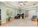 Bright living room showcasing a ceiling fan, hardwood floors, and a large window with natural light at 1450 Shady Meadow Ln, Deland, FL 32724