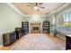 Spacious living room with a stone fireplace, hardwood floors, and large windows with natural light at 1450 Shady Meadow Ln, Deland, FL 32724