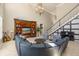 Open-concept living area with a cozy seating arrangement, grand staircase and piano at 1450 Shady Meadow Ln, Deland, FL 32724