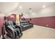 Entertainment room with carpet, dark red walls, and comfortable black leather couches at 1450 Shady Meadow Ln, Deland, FL 32724