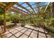 Open patio with a wood pergola provides natural lighting to this beautiful outdoor space at 1450 Shady Meadow Ln, Deland, FL 32724