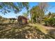 A wooden shed is nestled in a spacious backyard with a wood fence at 1450 Shady Meadow Ln, Deland, FL 32724
