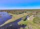 Scenic aerial view showcases the property's waterfront location and lush landscape, perfect for nature lovers at 1490 Kettledrum Trl, Enterprise, FL 32725