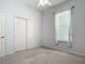 Neutral bedroom with carpeted floors, a double door closet, and a window providing natural light at 1490 Kettledrum Trl, Enterprise, FL 32725