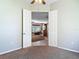 View from carpeted bedroom looking into dining area with a dining set and tile floor at 1490 Kettledrum Trl, Enterprise, FL 32725