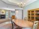 A dining room showcasing a wood table, chairs, and cabinet near the fireplace at 1490 Kettledrum Trl, Enterprise, FL 32725