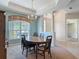 Elegant dining room with tray ceiling, chandelier lighting, and a large window for a bright atmosphere at 1490 Kettledrum Trl, Enterprise, FL 32725