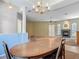 A dining room with a wood table, chairs, ceiling fan, and a fireplace at 1490 Kettledrum Trl, Enterprise, FL 32725
