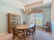 A traditional dining room featuring a wood table, chairs, cabinet, window, and chandelier at 1490 Kettledrum Trl, Enterprise, FL 32725