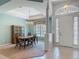Dining room with a table, chairs, cabinet, and an entryway featuring a door at 1490 Kettledrum Trl, Enterprise, FL 32725