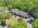 Aerial view of a charming brick home surrounded by mature trees and lush landscaping, offering serene privacy at 1490 Kettledrum Trl, Enterprise, FL 32725