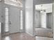 Inviting front foyer with tile floors, sidelight windows, and entrance to another room at 1490 Kettledrum Trl, Enterprise, FL 32725