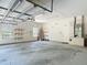 Spacious garage with high ceilings, shelving and a work area at 1490 Kettledrum Trl, Enterprise, FL 32725