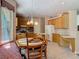 An eat-in kitchen area featuring light wood cabinets, a dining table and bench seating at 1490 Kettledrum Trl, Enterprise, FL 32725