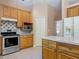 A kitchen featuring light wood cabinets and stainless steel appliances at 1490 Kettledrum Trl, Enterprise, FL 32725