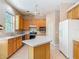 Bright kitchen with light wood cabinets, a functional island, and modern appliances for efficient cooking at 1490 Kettledrum Trl, Enterprise, FL 32725