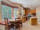 Charming kitchen with wood cabinets, tile flooring, and a cozy breakfast nook with large windows at 1490 Kettledrum Trl, Enterprise, FL 32725