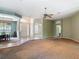 A living room featuring a dining area, entryway, and neutral walls at 1490 Kettledrum Trl, Enterprise, FL 32725