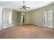 A spacious living room features neutral walls, large windows, and a ceiling fan at 1490 Kettledrum Trl, Enterprise, FL 32725