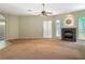 Large living room featuring a fireplace, carpet, large windows, and a smooth transition to tiled areas at 1490 Kettledrum Trl, Enterprise, FL 32725
