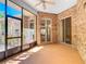 Enclosed brick patio with a ceiling fan and sliding glass doors for seamless indoor-outdoor living at 1490 Kettledrum Trl, Enterprise, FL 32725