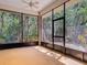 Relaxing screened porch with views of the trees creating a serene and bug-free environment at 1490 Kettledrum Trl, Enterprise, FL 32725