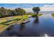 Scenic waterfront view featuring a wooden dock, picnic area, and access to the tranquil lake at 1490 Kettledrum Trl, Enterprise, FL 32725