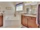 Bright bathroom with a large tub, shower, and neutral-toned fixtures at 1512 Lancashire Way, Deland, FL 32720