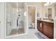 Bright bathroom with a granite vanity, tile floors, and a glass enclosed shower with a seat at 1512 Lancashire Way, Deland, FL 32720