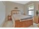 Cozy bedroom with warm, neutral colors and wooden furniture and decor at 1512 Lancashire Way, Deland, FL 32720