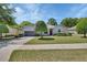 Charming home with a landscaped front yard, a shade tree, and a beautiful driveway at 1512 Lancashire Way, Deland, FL 32720