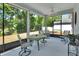 Relaxing screened lanai with a ceiling fan and comfortable seating with views of the backyard at 1512 Lancashire Way, Deland, FL 32720