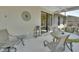 Enclosed patio with ceiling fan, outdoor furniture, and sliding glass doors to bring the outdoors in at 1512 Lancashire Way, Deland, FL 32720