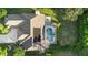 Aerial view of the property featuring a private backyard pool, lush landscaping, and a well-maintained roof at 1540 Park Forest Blvd, Mount Dora, FL 32757