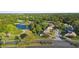 Aerial view of the property showcasing its location on a serene golf course, surrounded by lush greenery and a peaceful lake at 1540 Park Forest Blvd, Mount Dora, FL 32757