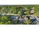 Aerial view showcasing homes near a golf course and lake, featuring screened patios and lush greenery at 1540 Park Forest Blvd, Mount Dora, FL 32757