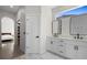 Bright bathroom featuring a double vanity with marble countertop and modern rectangular mirrors at 1540 Park Forest Blvd, Mount Dora, FL 32757