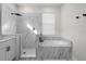 Modern bathroom featuring a glass-enclosed shower, soaking tub, and elegant tile work at 1540 Park Forest Blvd, Mount Dora, FL 32757