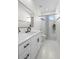 Bright bathroom featuring a marble-topped vanity with black fixtures, shower with curtain, and tiled floors at 1540 Park Forest Blvd, Mount Dora, FL 32757