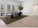 Bright, neutral dining room with modern furniture, hardwood floors, and a view of the backyard at 1540 Park Forest Blvd, Mount Dora, FL 32757