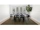 An open concept dining area features French doors, modern decor, light hardwood floors, and natural lighting at 1540 Park Forest Blvd, Mount Dora, FL 32757