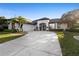 Charming home featuring a well-manicured lawn, elegant black trim, and a welcoming arched entryway with glass doors at 1540 Park Forest Blvd, Mount Dora, FL 32757
